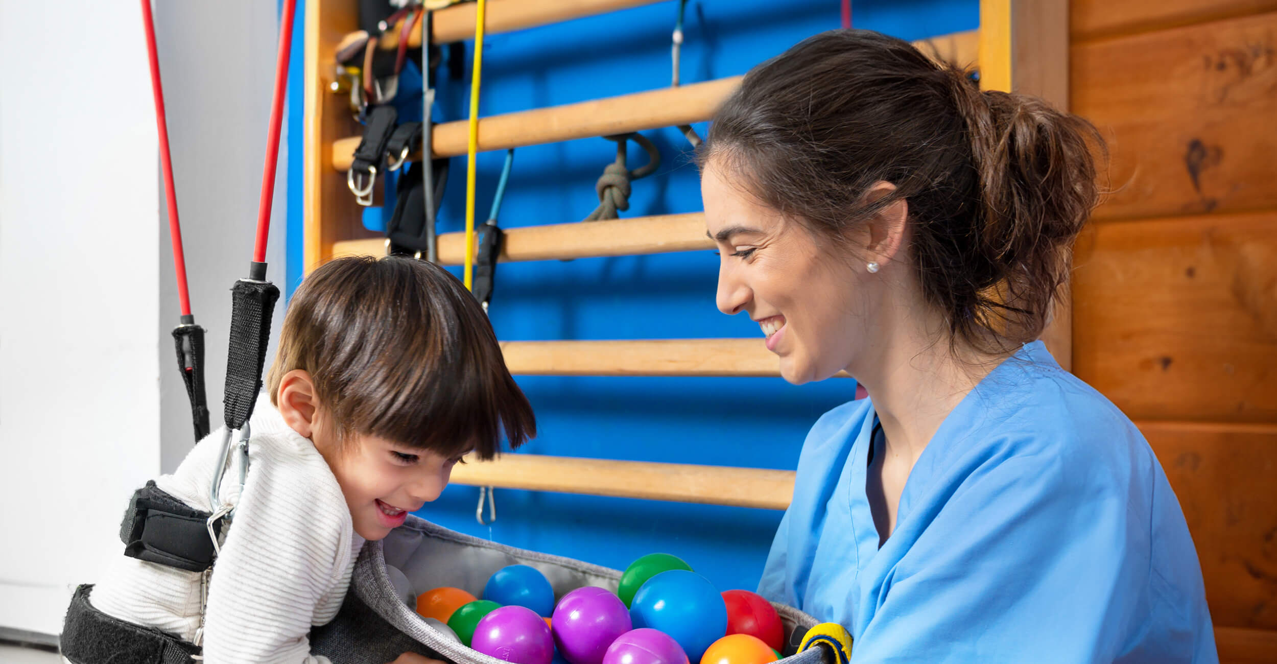 Physiotherapist helping child with cerebral palsy