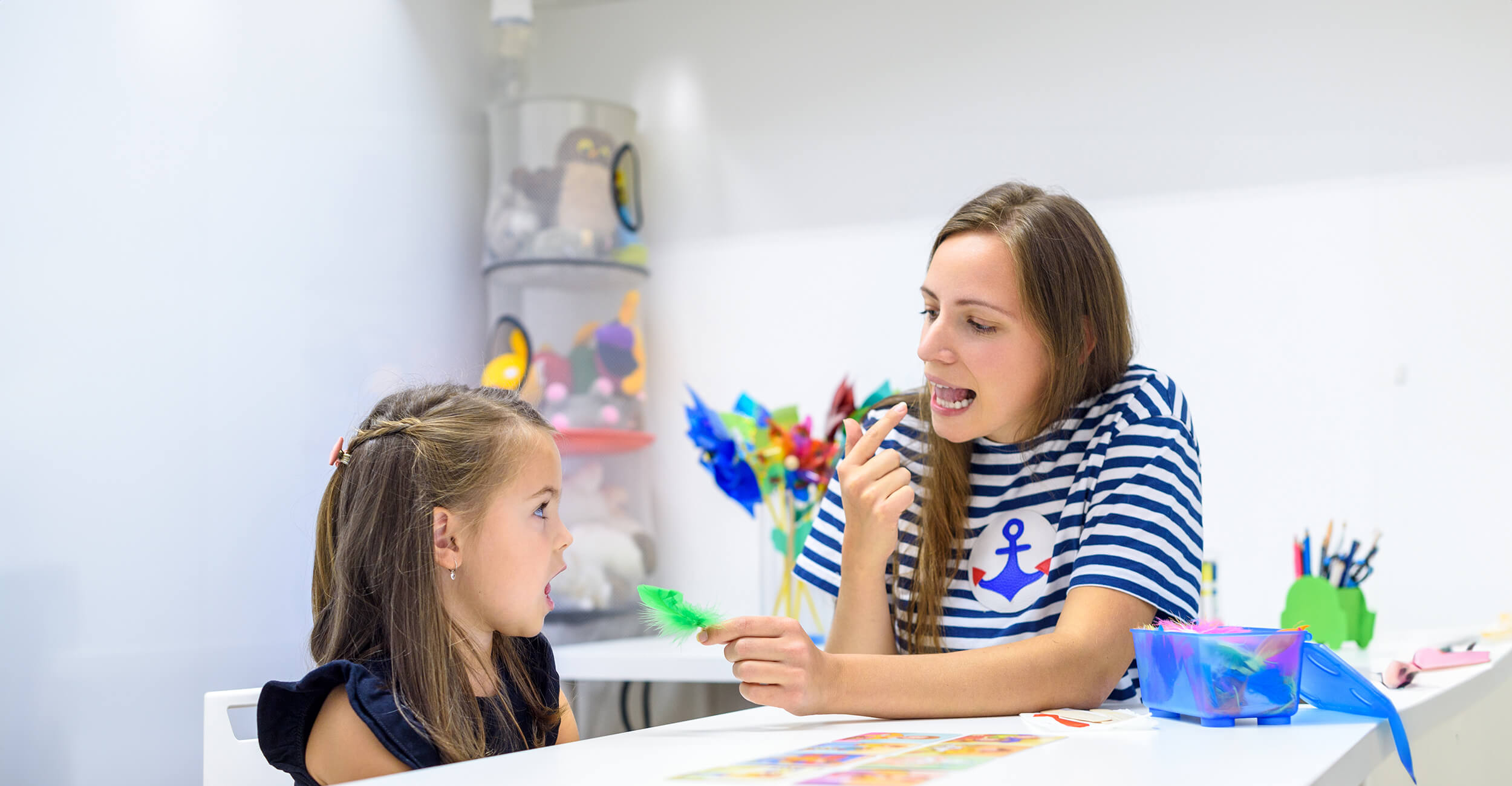 Speech therapist helping a child